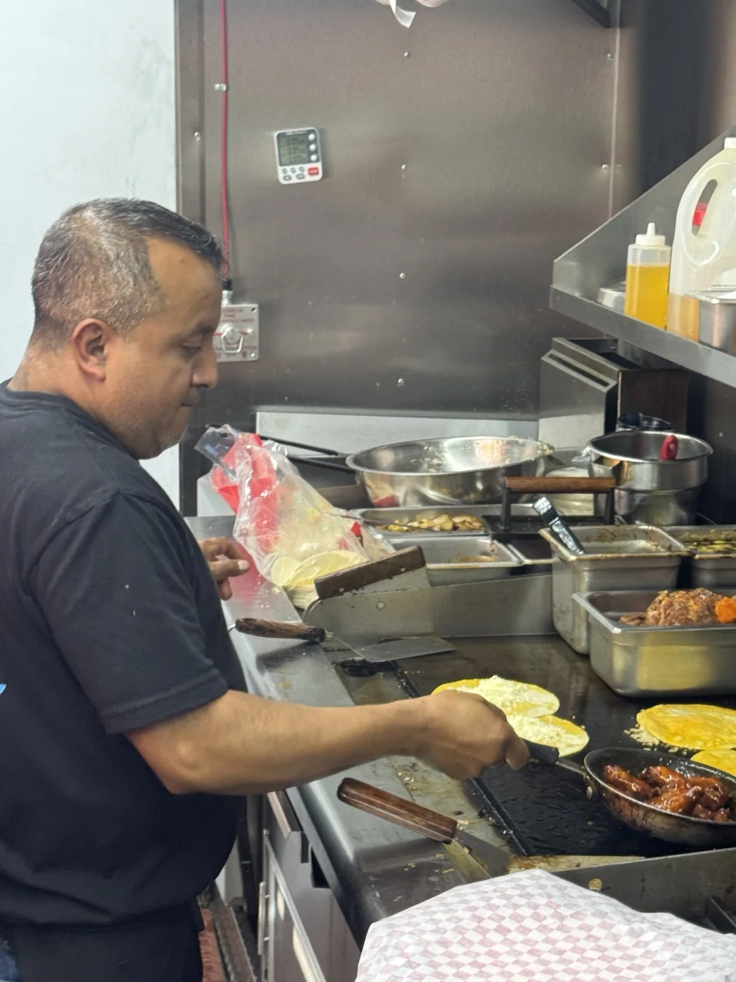 Food being prepared inside the No Manches food truck
